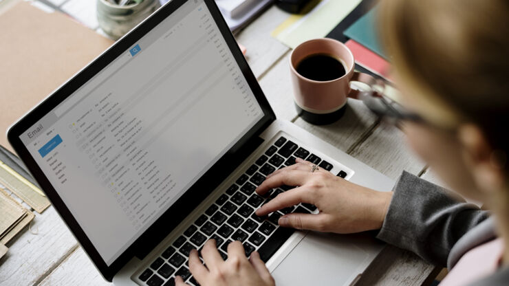 Person reading email on a laptop.