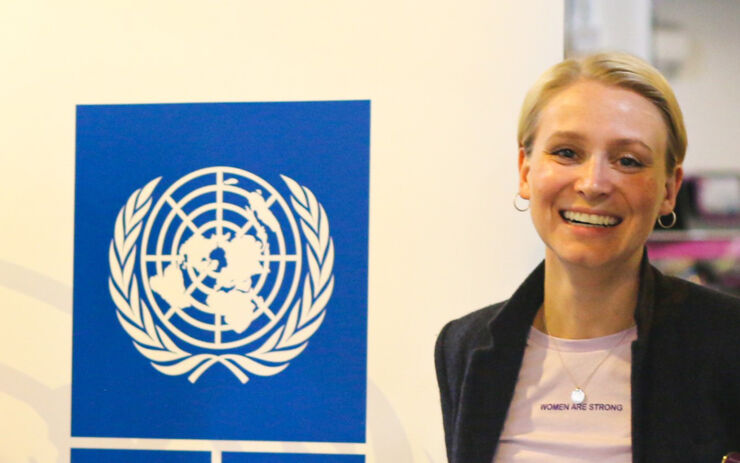 Lisette Frandsen-Albrechtsen in front of a UN logo.