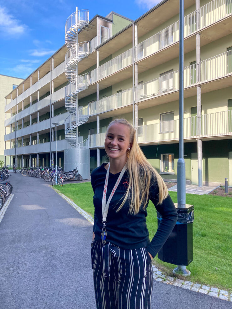 Picture of student outside student house. 