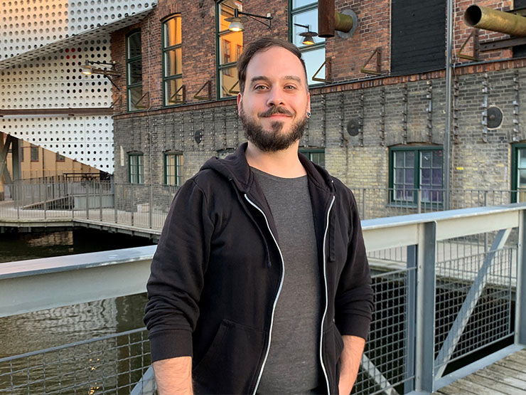 Portrait of a man on the bridge, brick building in the background