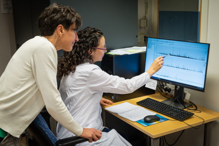 Susana Cristobal and Veronica Lizano-Fallas look at a computer.