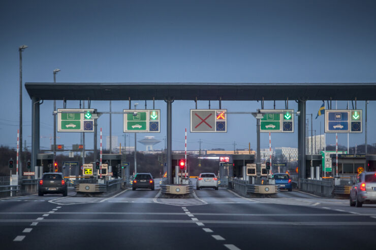 Cars driving through  bridge tull station