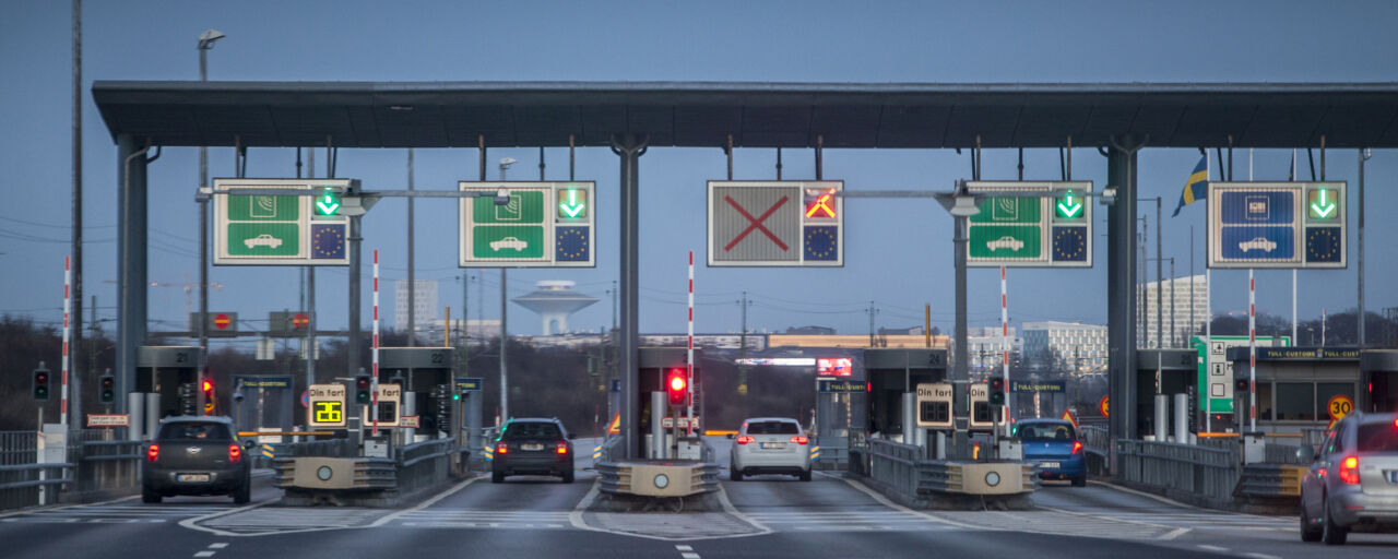 Cars driving through  bridge tull station