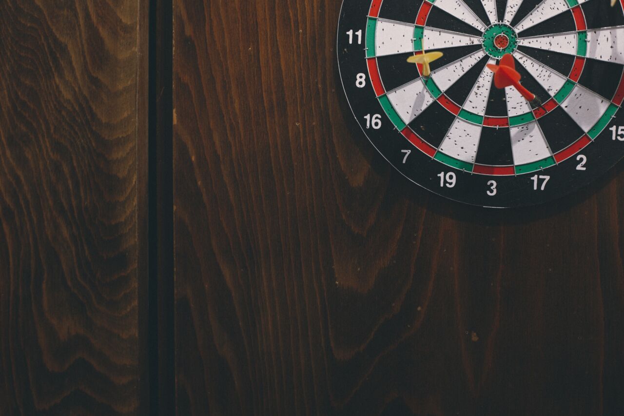 Darts on a dart board. 