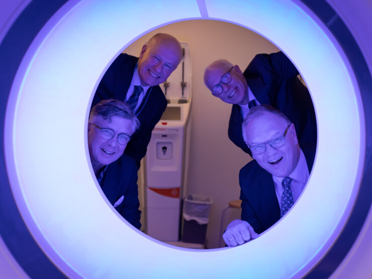 Photo of men looking through a  photon counting CT (PCCT).