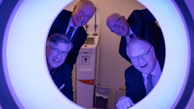 Photo of men looking through a  photon counting CT (PCCT).