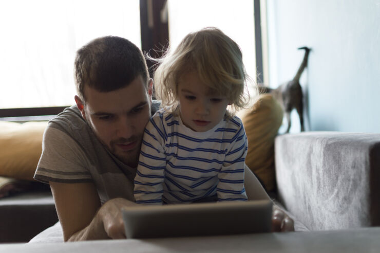 Child and parent reading from an ipad