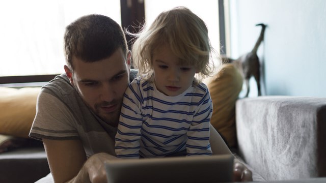 Child and parent reading from an ipad