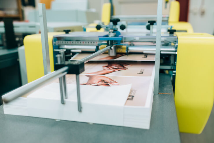 A cover being laminated in a laminating machine.