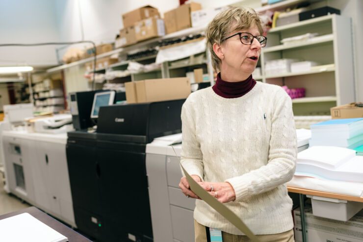 Anita Axby shows a proof printed on gold paper.