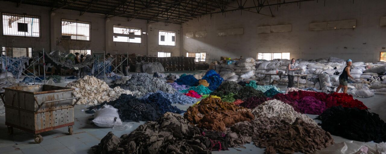 Sorting through hundreds of tons of clothing in an abandoned factory