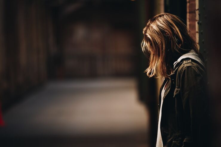 A girl stands in a dimly lit hallway on Alcatraz Island, SF.