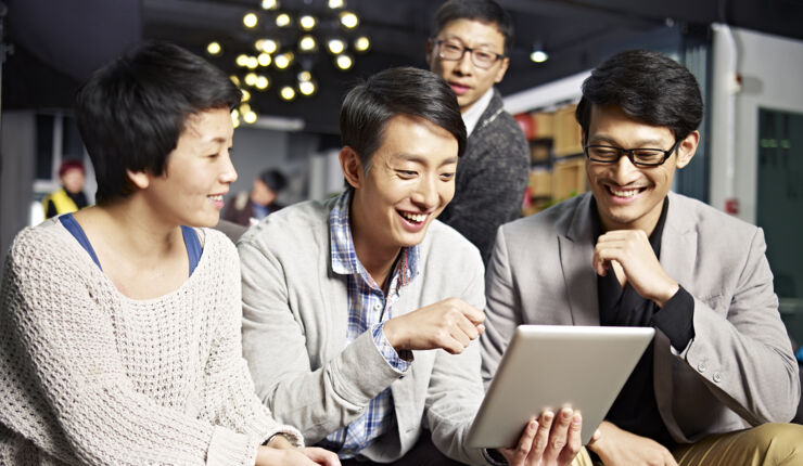 Three Chinese in front of a laptop.