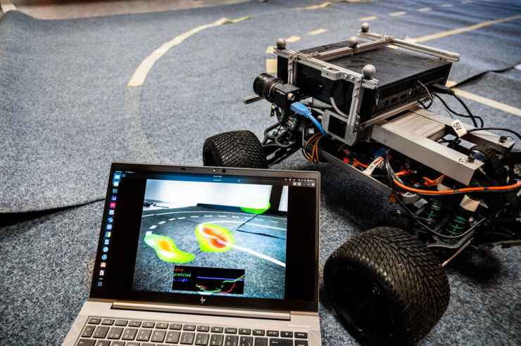 Small autonomous vehicle connected to laptop.