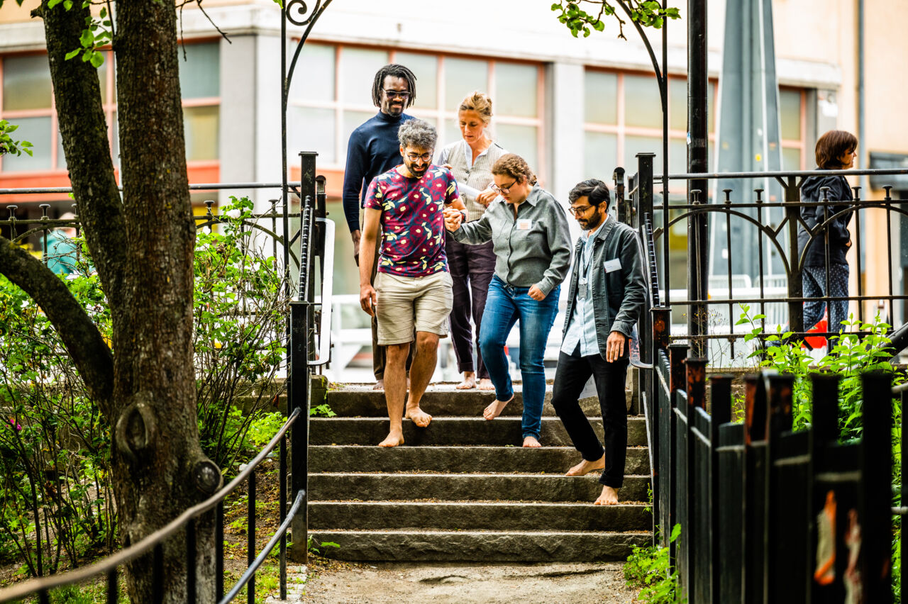 Five people on an outside staircase. 