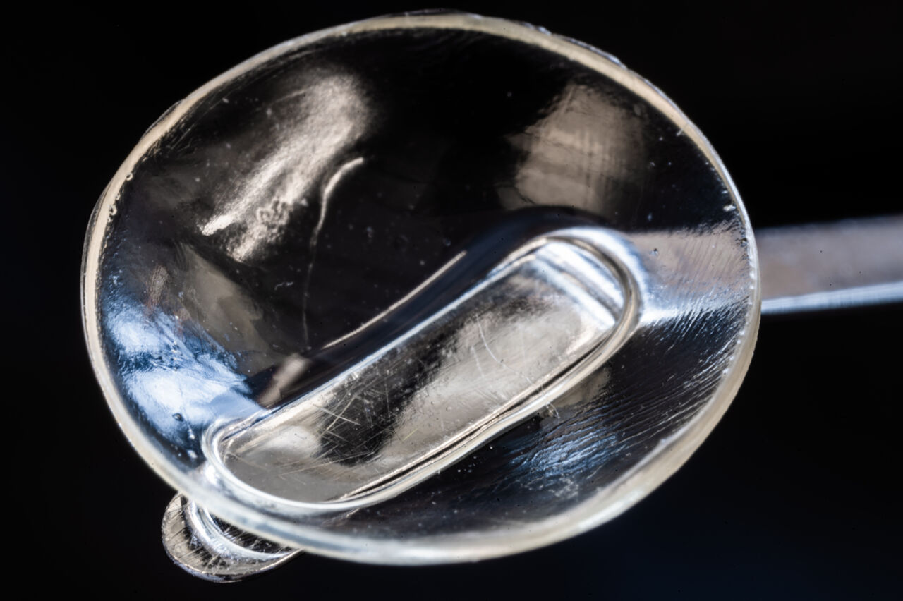 Transparent, disc-shaped implant.