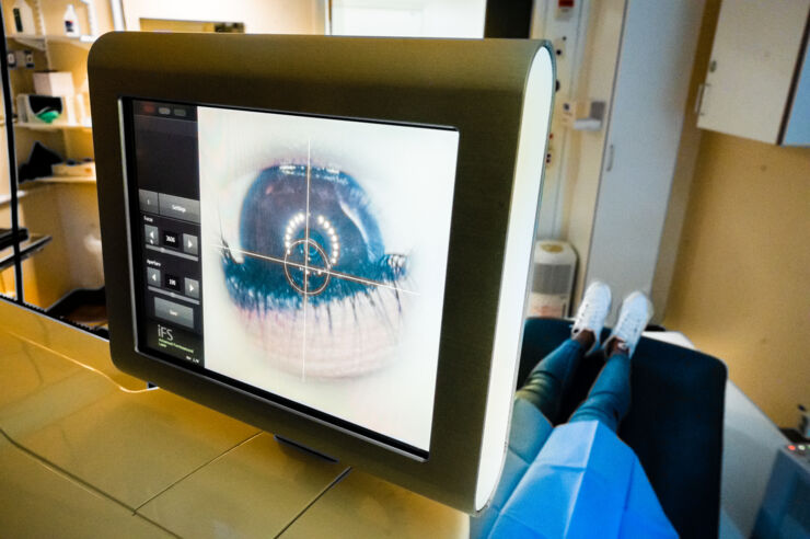 Picture of person having their eye examined in a machine.