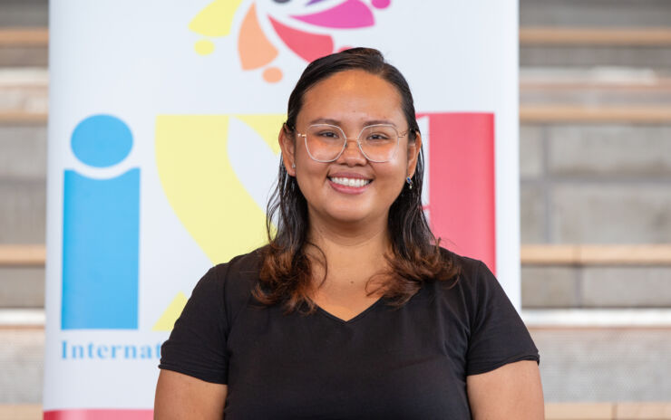 A student smiles and looking into the camera.