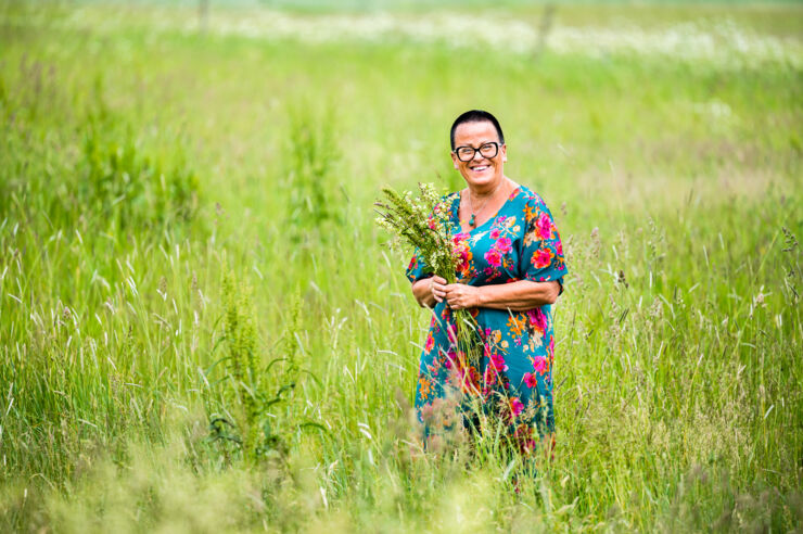Gunilla Lööf standing in a flower meadow