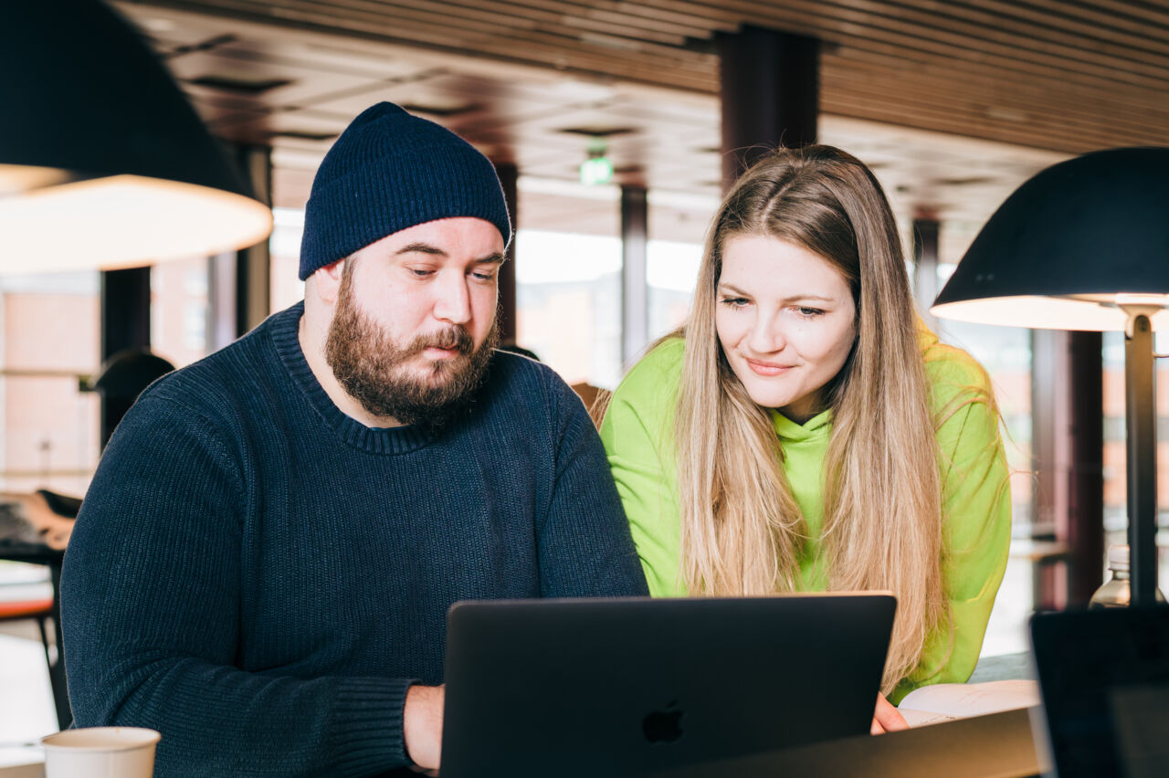 Two students using a laptop