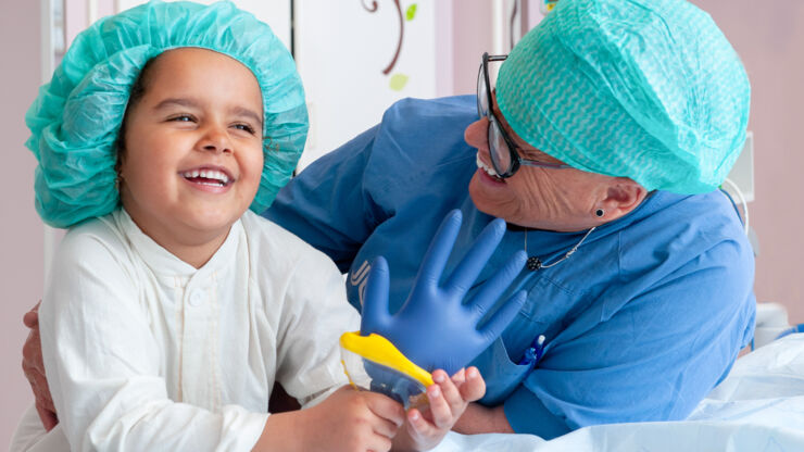 A nurse, sitting with a child.