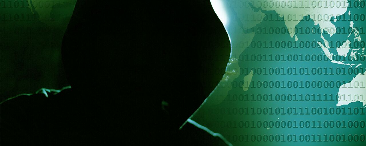 A person in black hoodie with the binary code in background.