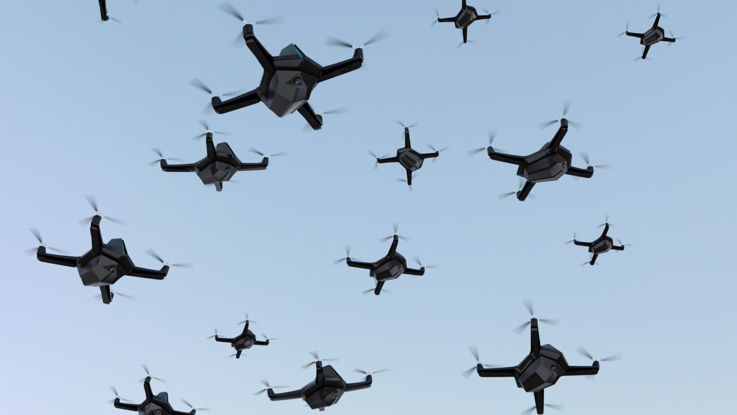 Swarm of drones on blue sky.