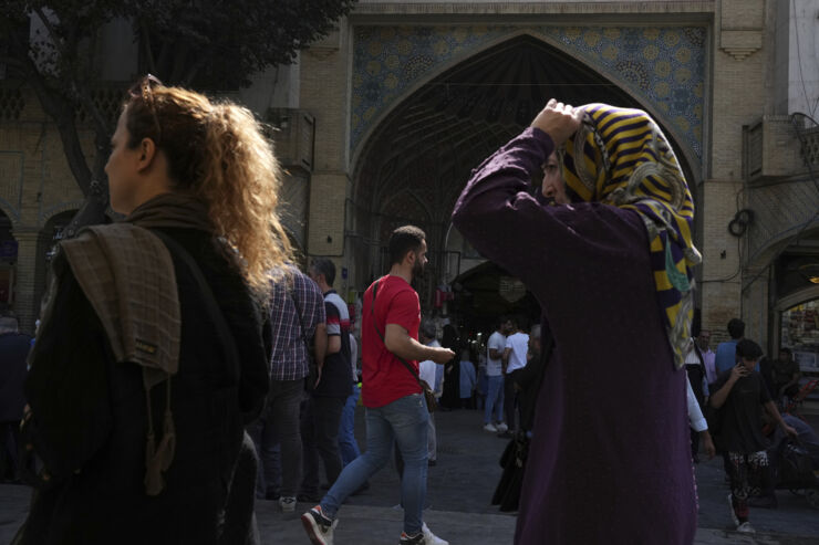 Two women outside market in Tehran.