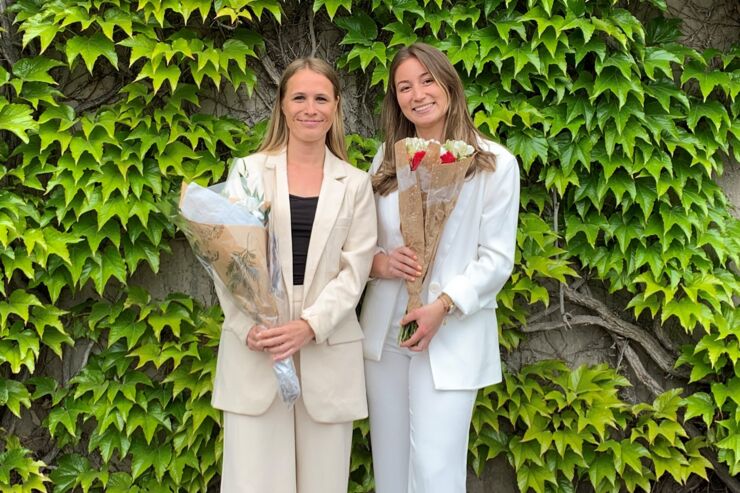 Two women holding flowers.