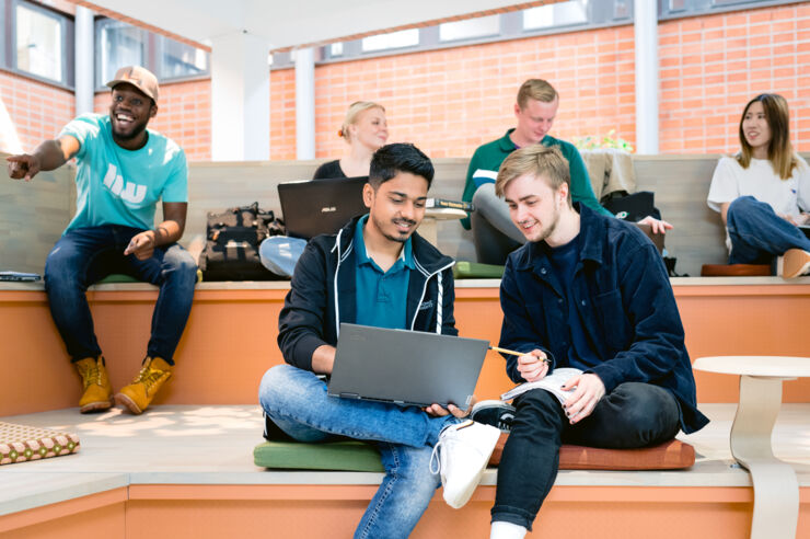 Students checking out something on a laptop