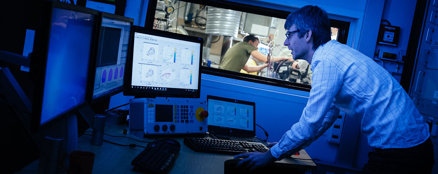 A person looking at a monitor in a lab.