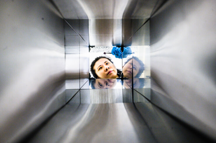 Photograph of a researcher taken through an aluminium tube.