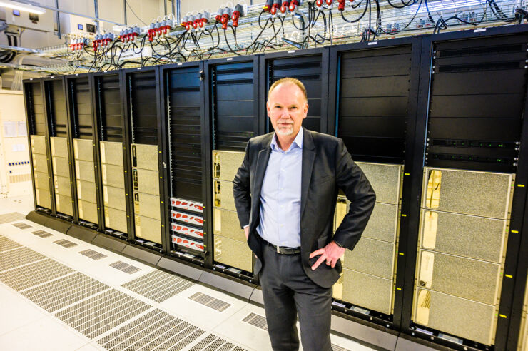 Man infront of supercomputer.