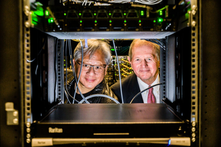 Two men looking through a hole in a supercomputer.