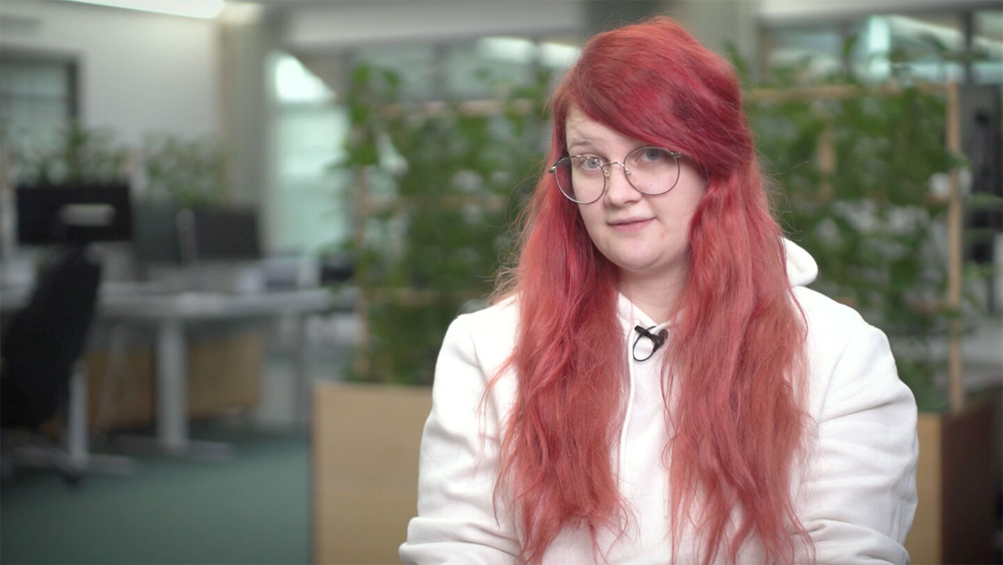 Young red-haired woman wearing round glasses