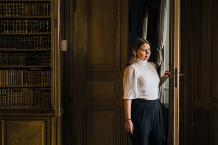 Woman walking through a door.