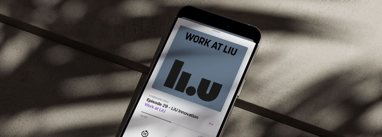 Smartphone lies on a stone floor and showing the podcast Work at LiU on the screen.