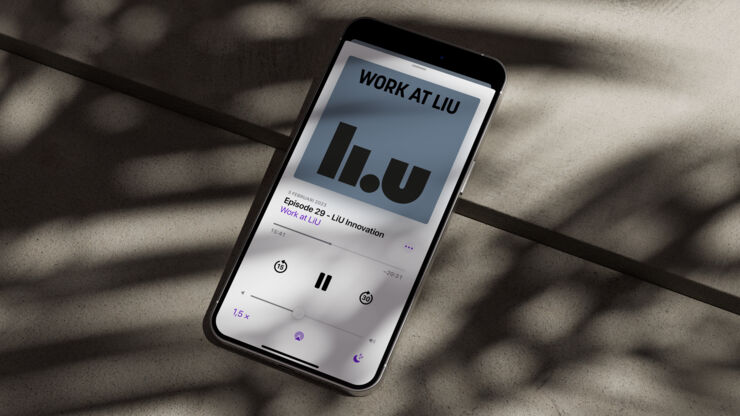 Smartphone lies on a stone floor and showing the podcast Work at LiU on the screen.