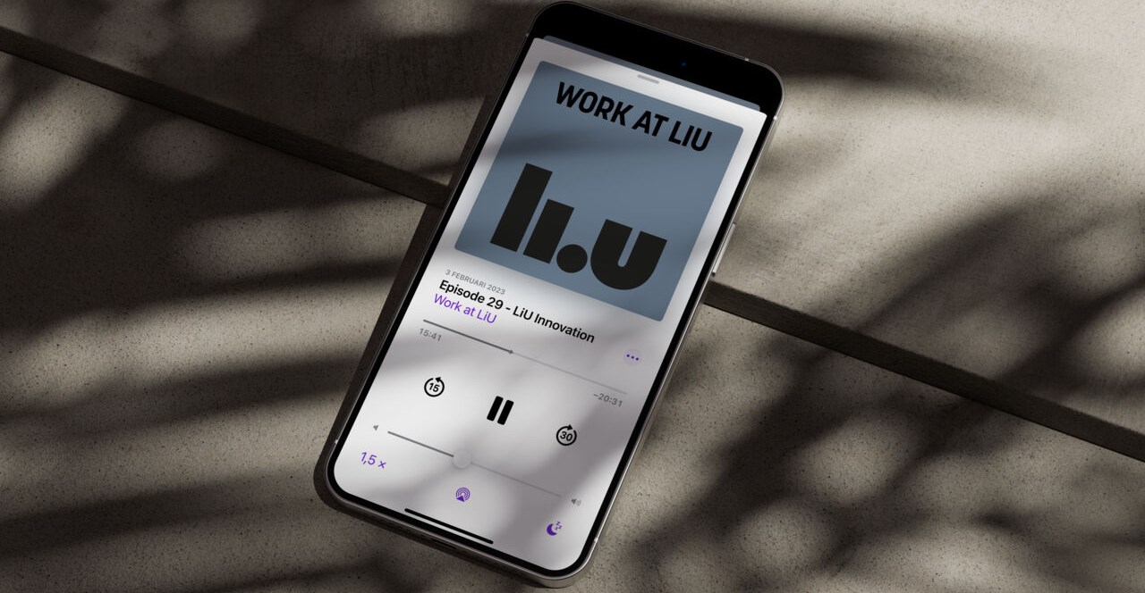 Smartphone lies on a stone floor and showing the podcast Work at LiU on the screen.
