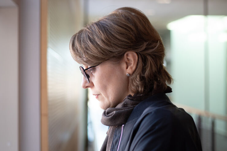 Profile of a women with her head slightly bent.