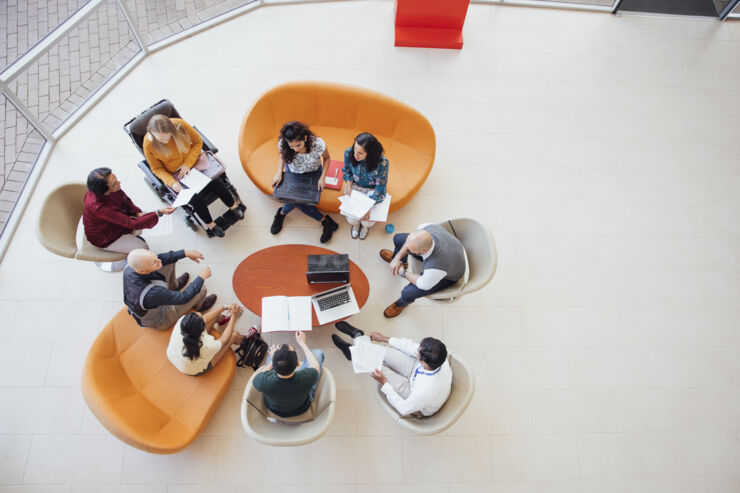 People sitting at a table at a meeting.