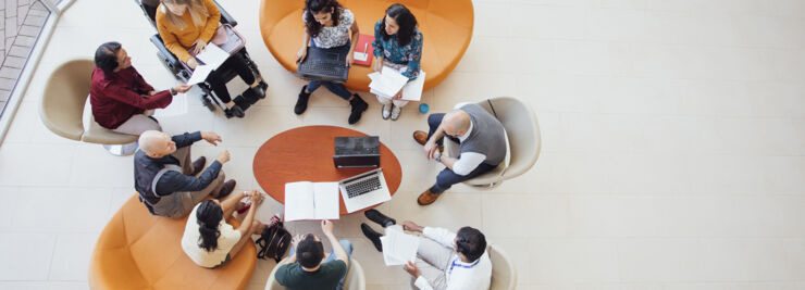 People sitting at a table at a meeting.