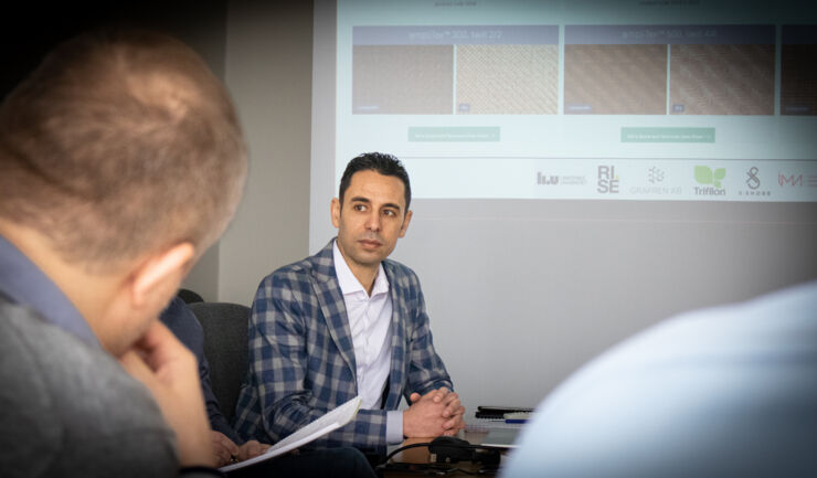 Male scientist in discussion at a meeting.