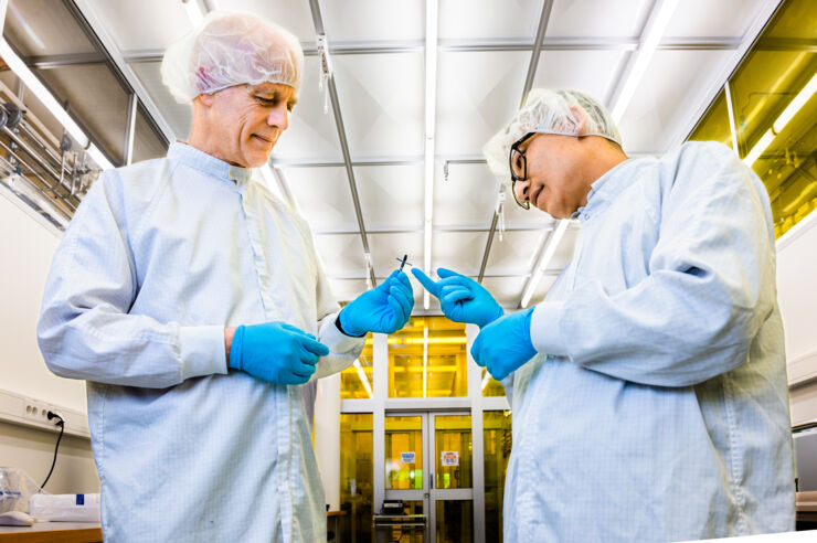 Two researchers in labcoats in a lab.