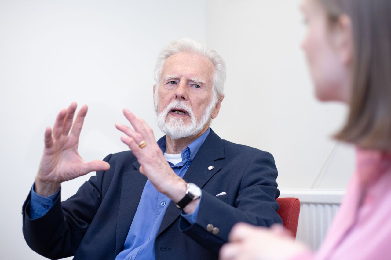 Older man engaged in a discussion.