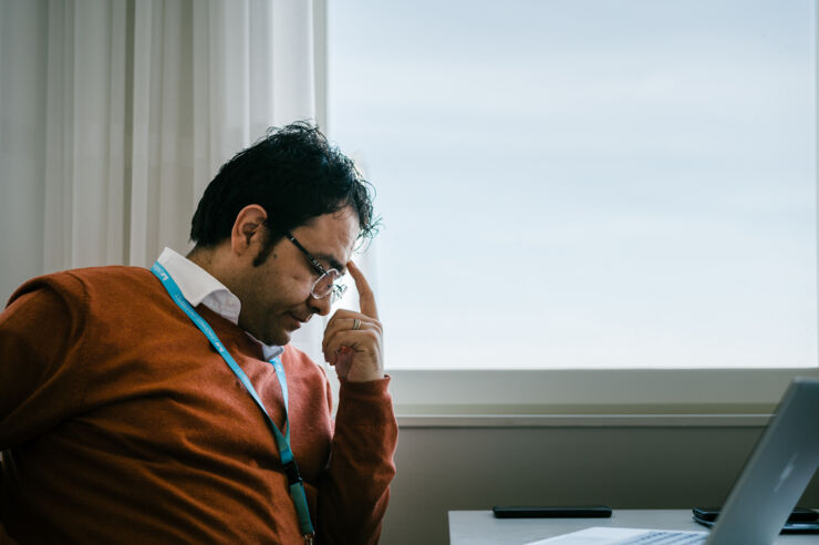 Man in front of a window, looking worried.