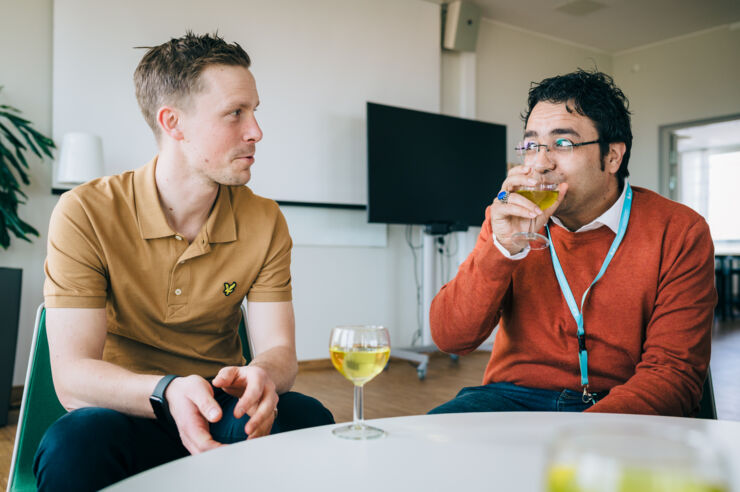 Two men at a table, drinking tea.