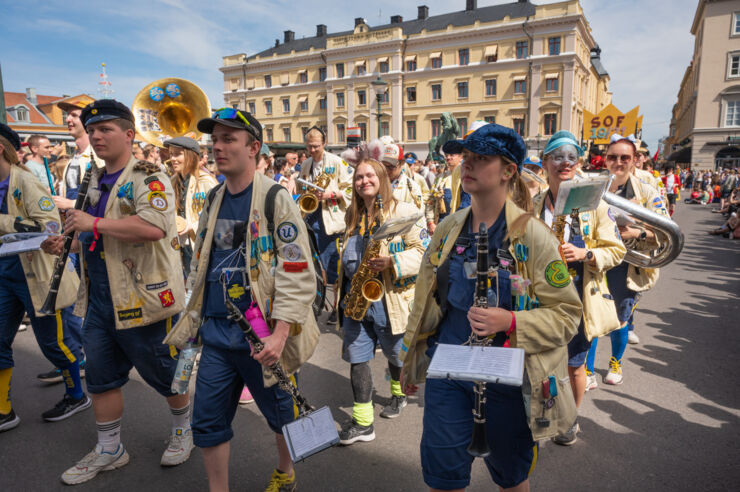 A brass band walks down a street