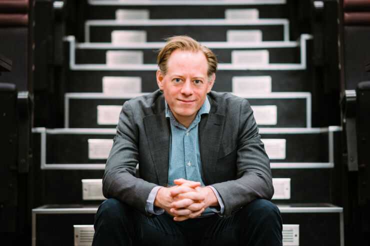 Portrait of Fredrik Heintz sitting on a staircase