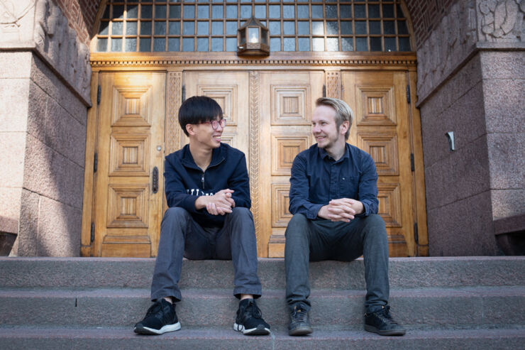 Two persons sitting on a stairway. 